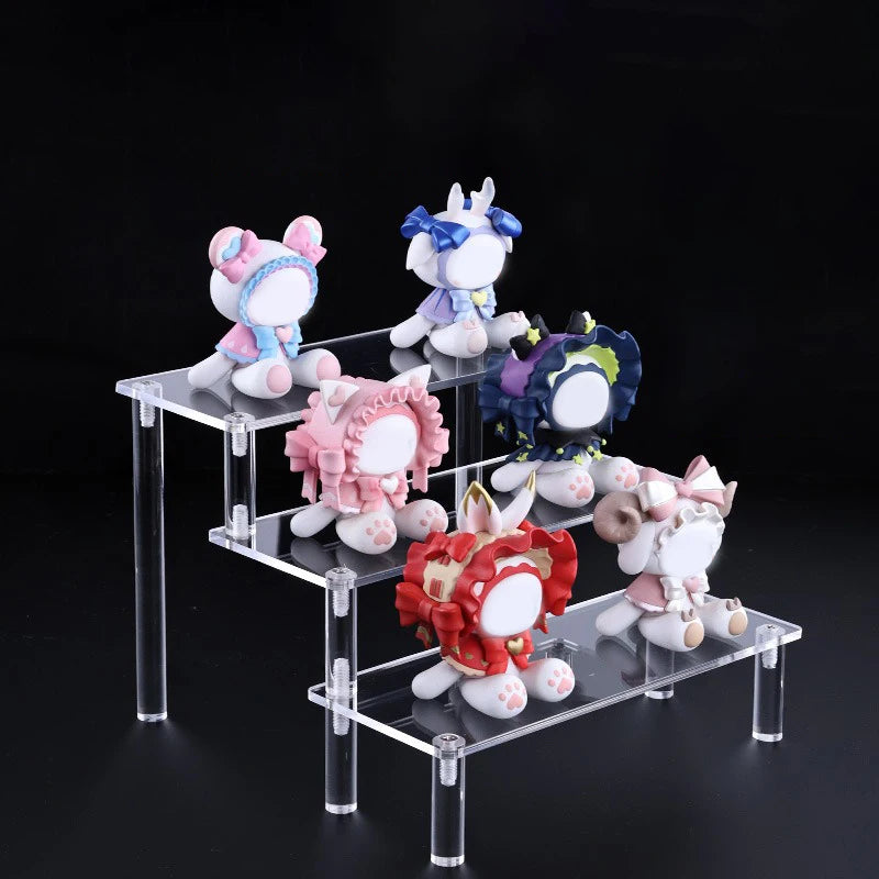 Clear tiered display stand holding colourful figurines