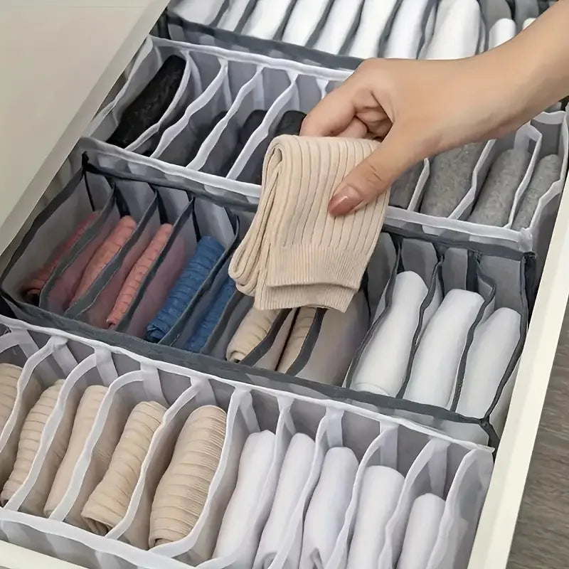 Divided mesh organisers arranging folded clothing in a drawer