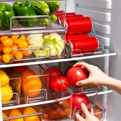 Clear refrigerator organiser bins neatly arranging fresh produce and drinks